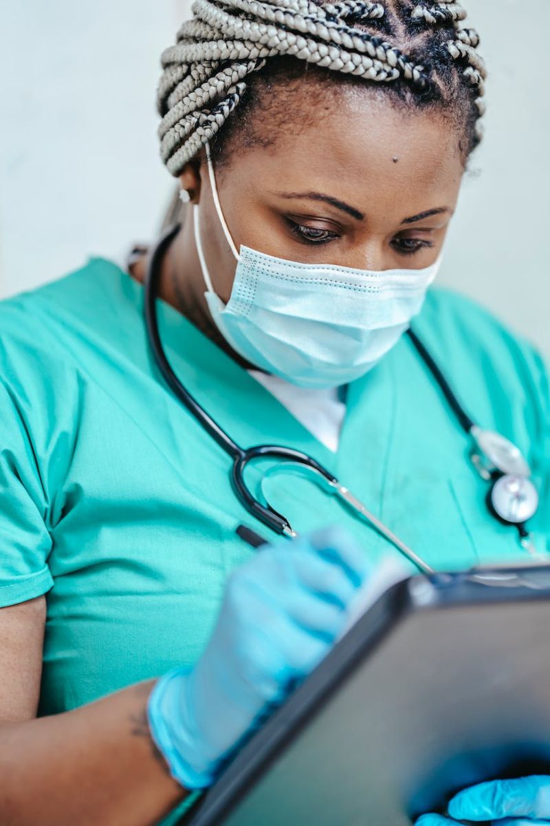 Midwife with clinical notes in a Network One Health consulting room